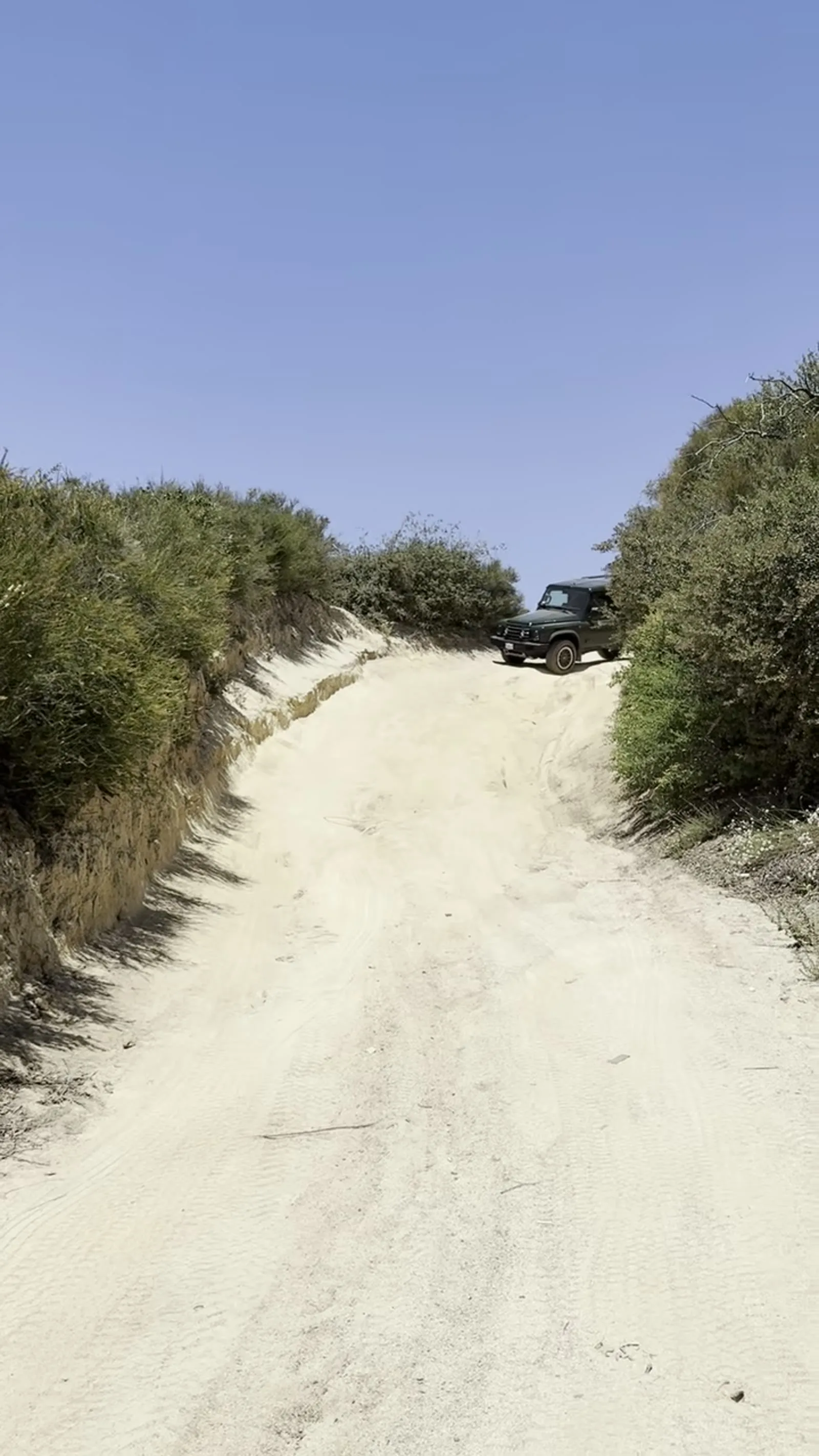 Grenadier climbing a sandy desert trail